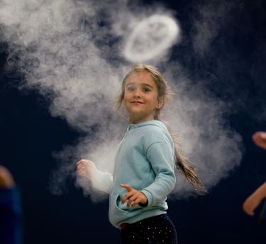 Girl looking at smoke ring from Infinity Blue sculpture
